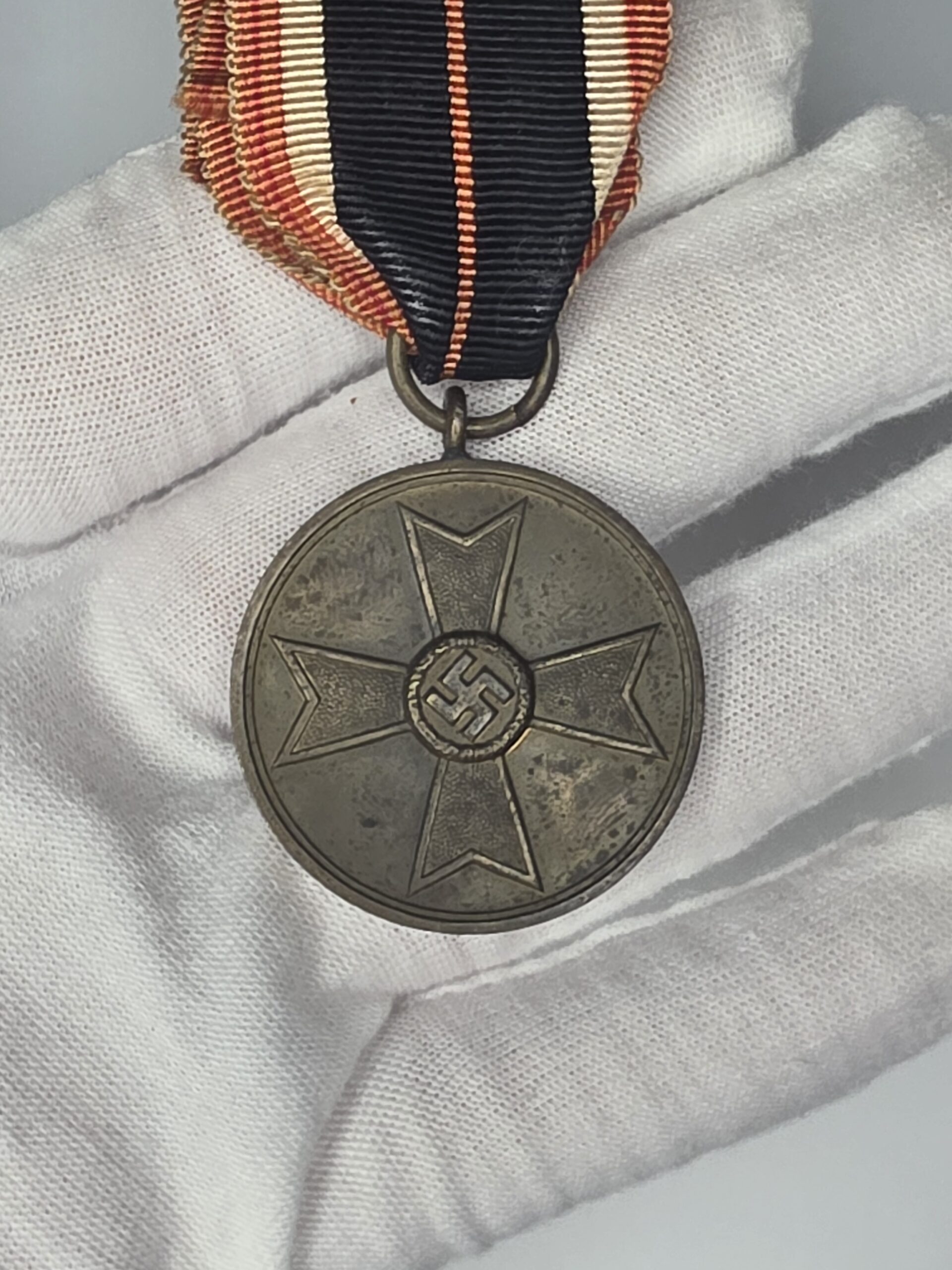 German War Merit Medal 1939 obverse and ribbon with narrow red centre stripe