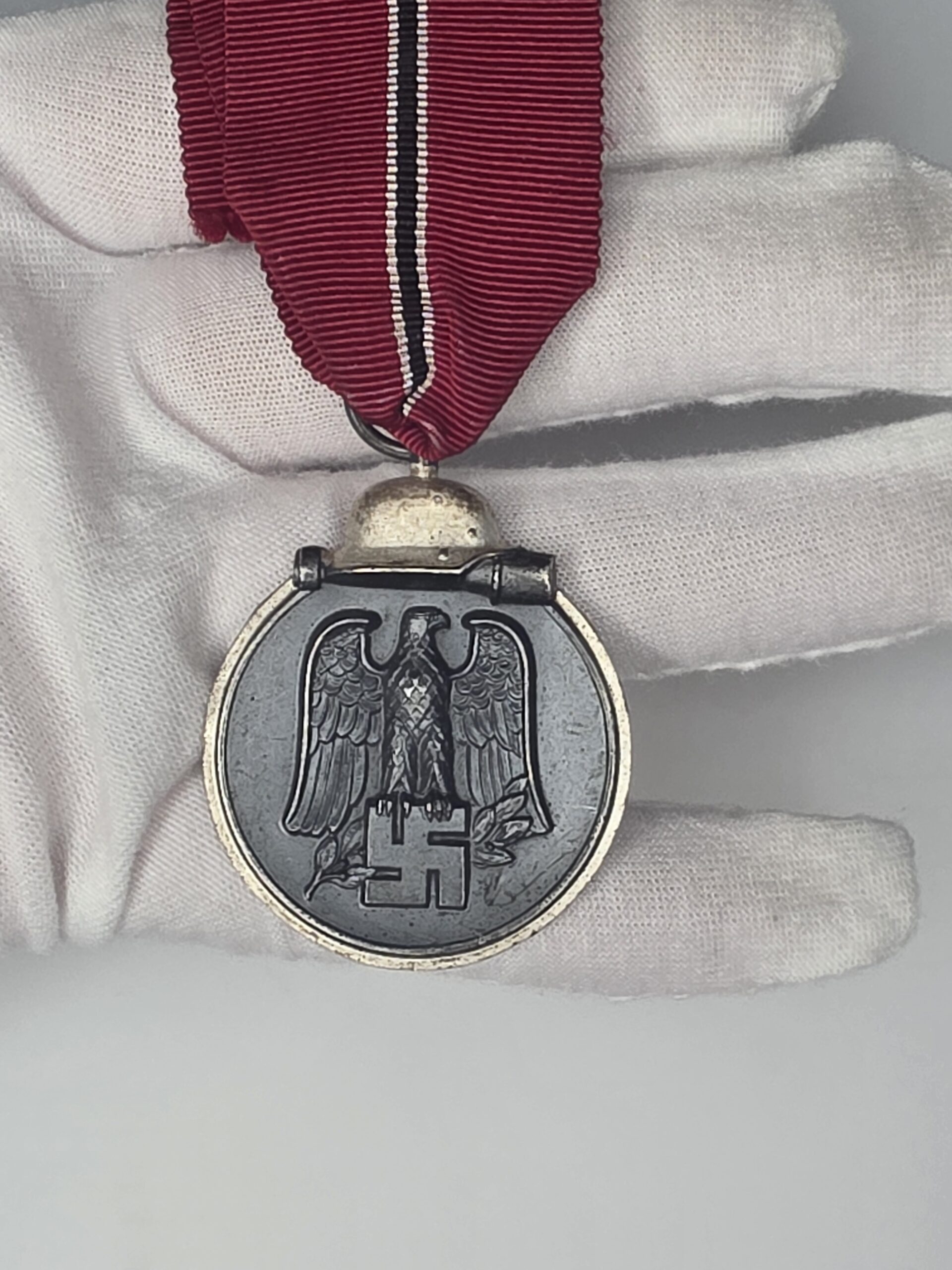 German Ostmedaille obverse eagle and helmet detail with red white black white ribbon