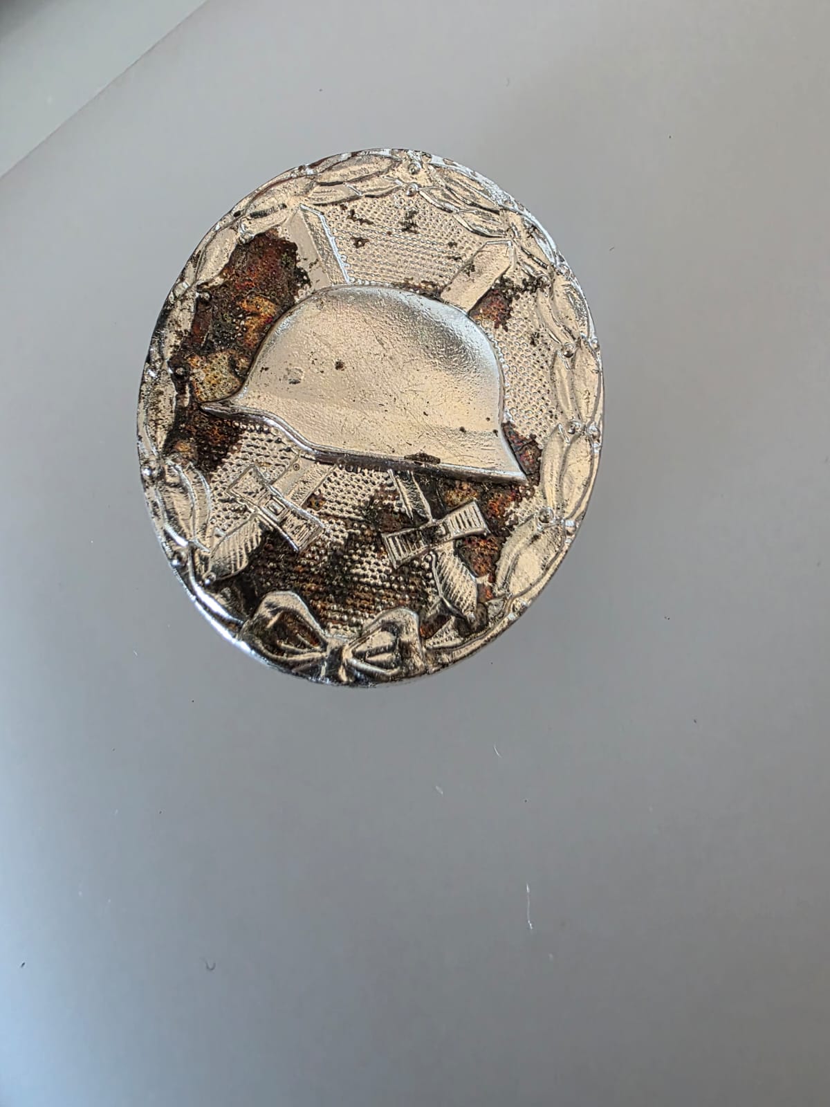Original 1957 German Silver Wound Badge Front Original German 1957 Silver Wound Badge with helmet crossed swords and laurel wreath