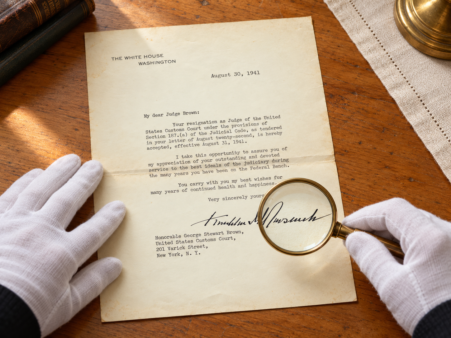 Original documents: examining a 1941 typed letter with a magnifying glass and white gloves