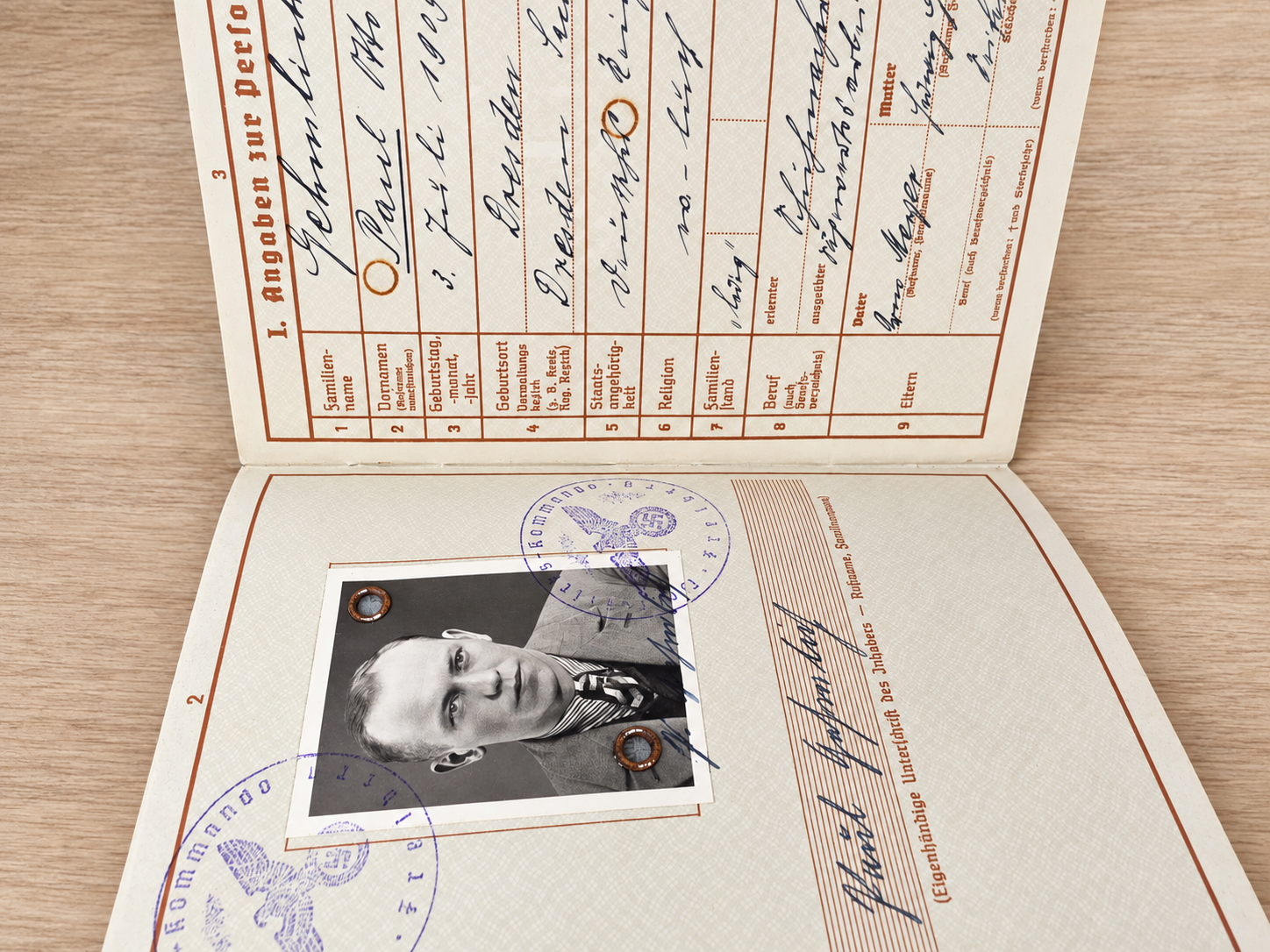 Illustrative Wehrpass personal page with photograph, unit entries and official stamps for reading WWII German military abbreviations